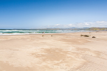 View of a waves breaking on the sand in, in Morrow Bay, California