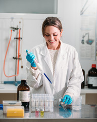 young woman scientist working with a pipette in a laboratory