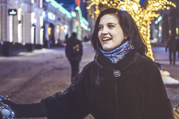 Fototapeta premium young woman walking in the street with baloon at night