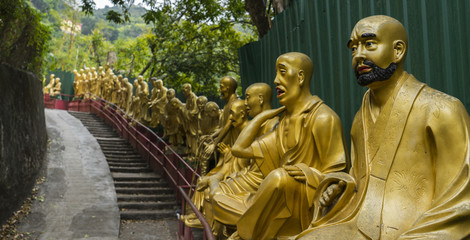 golden monk statues along stairway