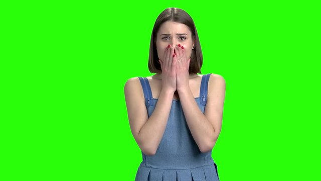 Portrait of woman is crying. Green screen hromakey background for keying.