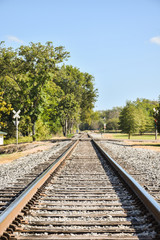 Fototapeta na wymiar Straight railroad tracks disappearing in the distance