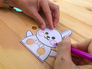 hand of kid painting the Greeting animal cards by coloured pencil,education concept