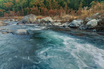 River water flowing through rocks at dawn