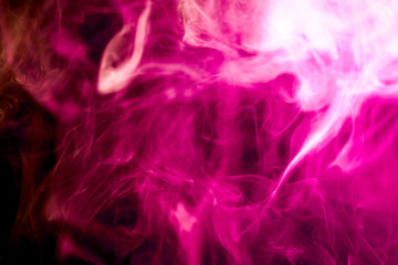 Colorful  pink  and purple smoke  on a black isolated background. Background from the smoke of vape