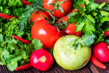 Fresh vegetables and herbs on wooden table