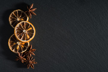 a composition of dried lemons and anise on natural slate