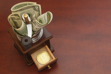 Exchange bitcoin concept, convert money to bitcoin, grinder with bitcoin coin and dollars on wooden table