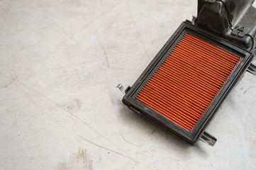 closeup old air filter for car in the garage with soft-focus and over light in the background