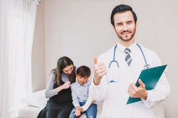 Obraz premium Doctor with cute little boy and mom showing thump up OK signs in hospital