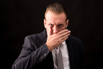 Businessman with black suit isolated on black background