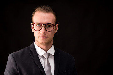 Businessman with black suit isolated on black background