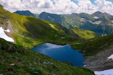 Fototapeta na wymiar lake Capra in Fagarasan mountains of Romania. beautiful summer scenery on a cloudy day. Popular tourist destination for Hiking.