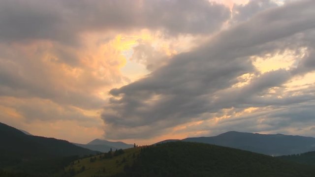 Beautiful countryside scenery with dramatic cloudy sky and mountains range, time lapse
