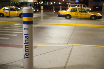 Pole with TERMINAL 1 at the airport of the country side in America. America is a continent where...