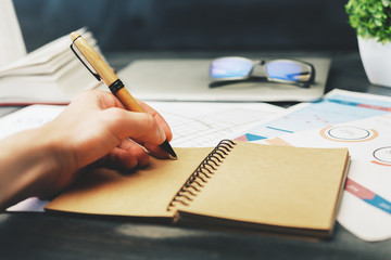 Male hand writing in notepad