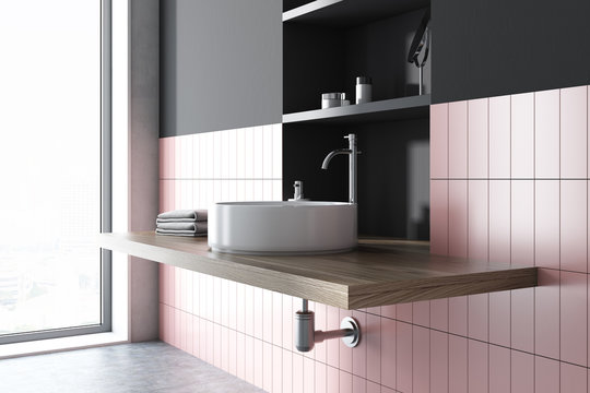 Sink in a pink and gray bathroom interior