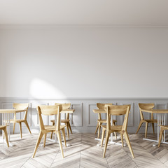 Modern white coffee shop, wooden chairs close up