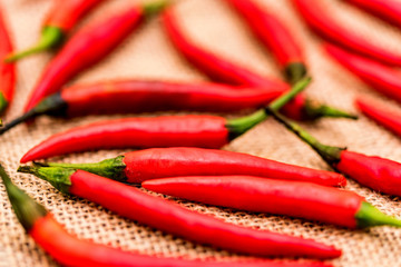 Red chili peppers on beige canvas cloth