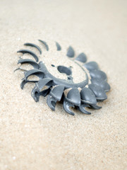 Fototapeta na wymiar Plastic Pelton water turbine on sand with out water