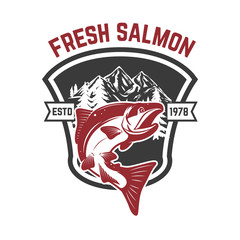 Salmon fishing. Salmon on background with mountains. Design element for logo, label, emblem, sign.