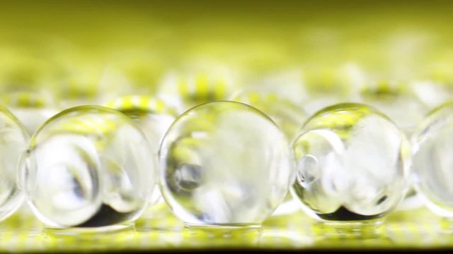 Yellow shiny water gel balls. Can be used for advertising or cosmetics, jewellery and for medicine. Abstract background.