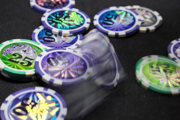 Many game chips with different denominations, different colors on the gaming table.  Passion, game, poker, casino.
