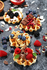 Belgian waffles with pomegranate and raspberries, homemade healthy breakfast with mint