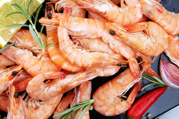Raw fresh Prawns Langostino Austral. shrimp seafood with lemon and spices.