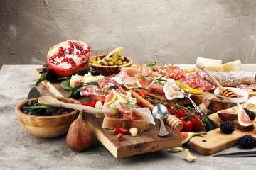 Italian antipasti wine snacks set. Cheese variety, Mediterranean olives, pickles, Prosciutto di Parma and salami