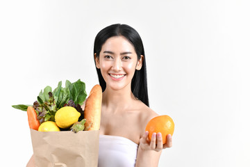 Obraz premium shopping concepts. Beautiful girls are buying fruits and vegetables. Beautiful girl to buy healthy food. Beautiful girl shopping at the bazaar. Asian girl suffocating bags of fruits and vegetables