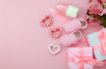 Top view aerial image of decoration Happy mother’s day holiday background concept.Flat lay sign of season the pink rose with kid shoe and child toys  on pink paper at home office desk.