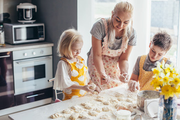 Maman cuisine avec des enfants dans la cuisine