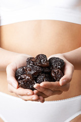 Close Up Of Woman In Underwear Holding Dried Prunes