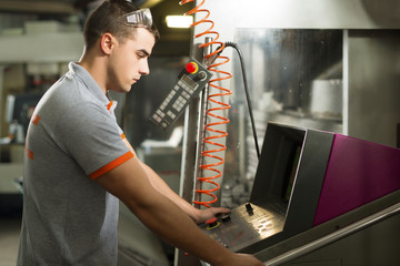 Metal Worker Working On  CNC Machine