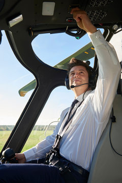 Pilot In Cockpit Of Helicopter Before Take Off