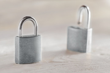 estate concept with symbol of security, lock padlock with key on wooden background.