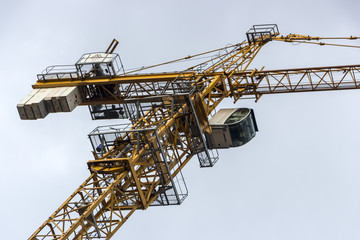 Tower crane against the blue sky, close up, details
