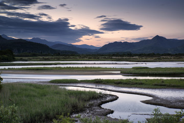 View looking towards Snowdonia mountain range landscape during a summer sunset