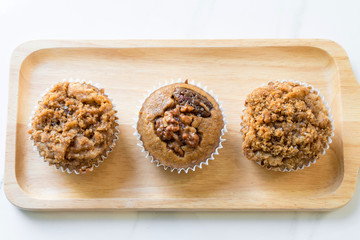 Banana crumble cup cake on wood plate.
