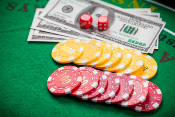 Poker chips and banknotes on table in casino