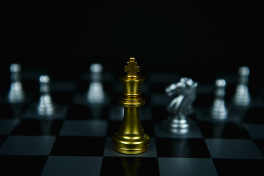 Leadership Concepts. Chess is a leader.  Comparing chess is a strategic business plan. Businessman is playing chess. Chess game on a black background.