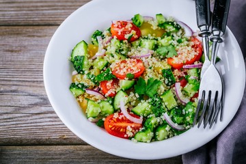 Quinoa Tabbouleh salad bowl with cucumbers, tomatoes, red onions and parsley