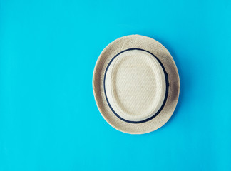 Fototapeta na wymiar Straw hat on blue background