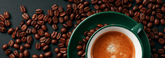 strong black coffee in a mug of emerald color on a black matte background