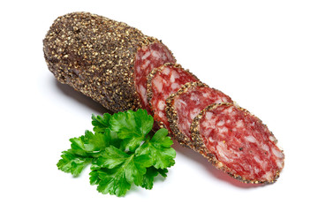 Dried organic salami sausage covered with pepper on white background