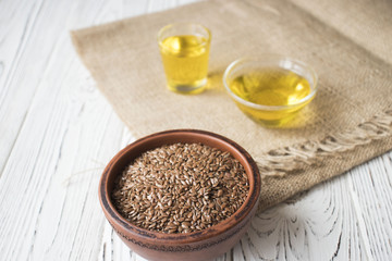 flax seeds in a clay pot on a wooden table