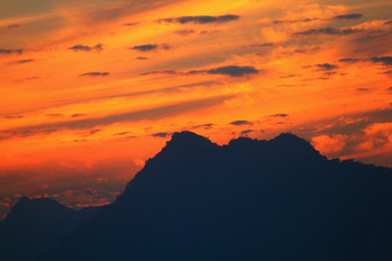 Sunset in sky and cloud, beautiful colorful twilight time with mountain silhouette