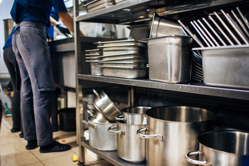 kitchen rack with clean pots and trays