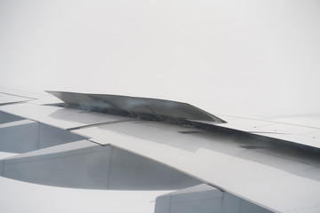 closeup of airplane wing during landing in heavy clouds